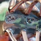 Close-up of the artisans stamped signatures.