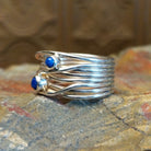 Sterling silver ring with layered, wiry band and lapis set in the bezels.