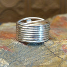 Sterling silver ring with layered, wiry band and lapis set in the bezels.