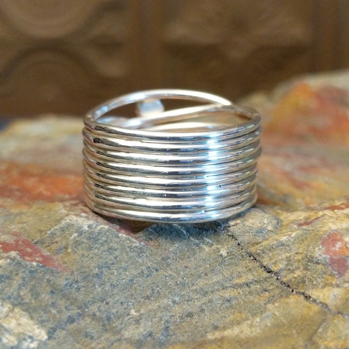 Sterling silver ring with layered, wiry band and lapis set in the bezels.
