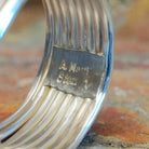 Close-up of the artisan's stamped signature.