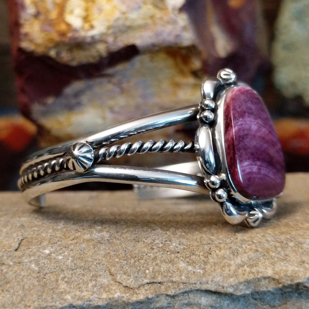 Purple spiny oyster shell cuff set in sterling silver with ornate details on the band.