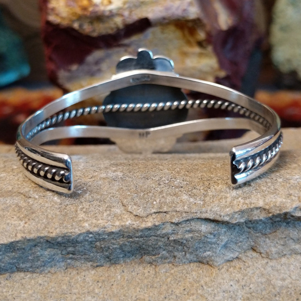 The back of the cuff showcases the polished silver and twisted rope band.