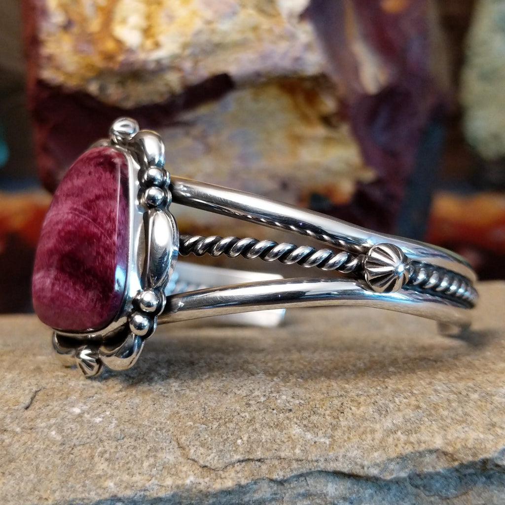 Purple spiny oyster shell cuff set in sterling silver with ornate details on the band.