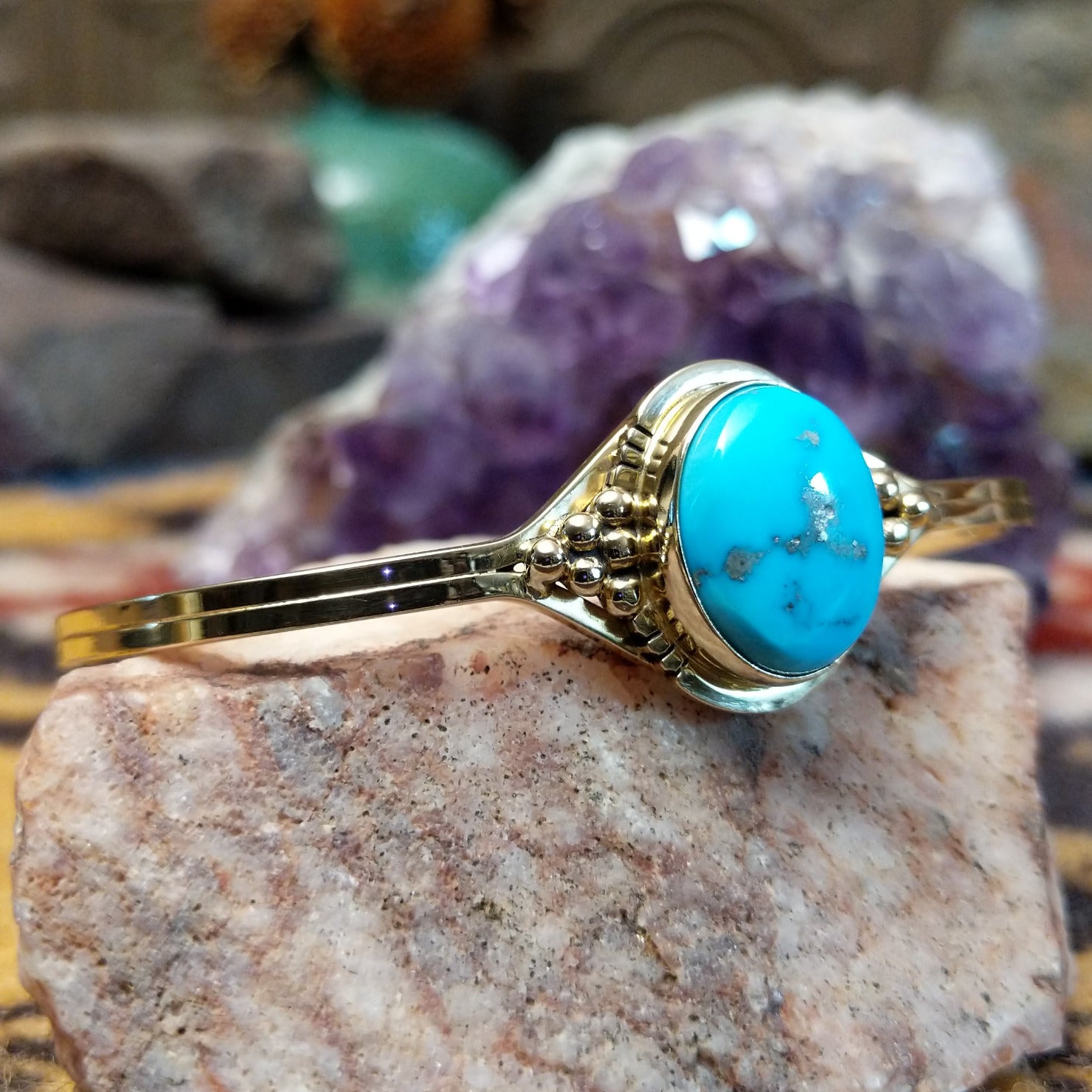 14k gold cuff by Tom Lewis with oval turquoise stone and bead accents.