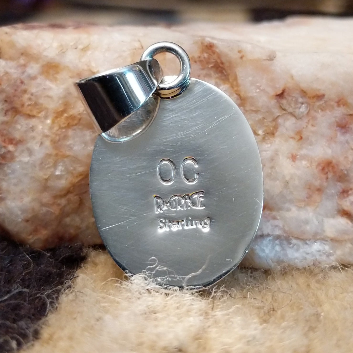 Close-up of the artisan's stamped signature.