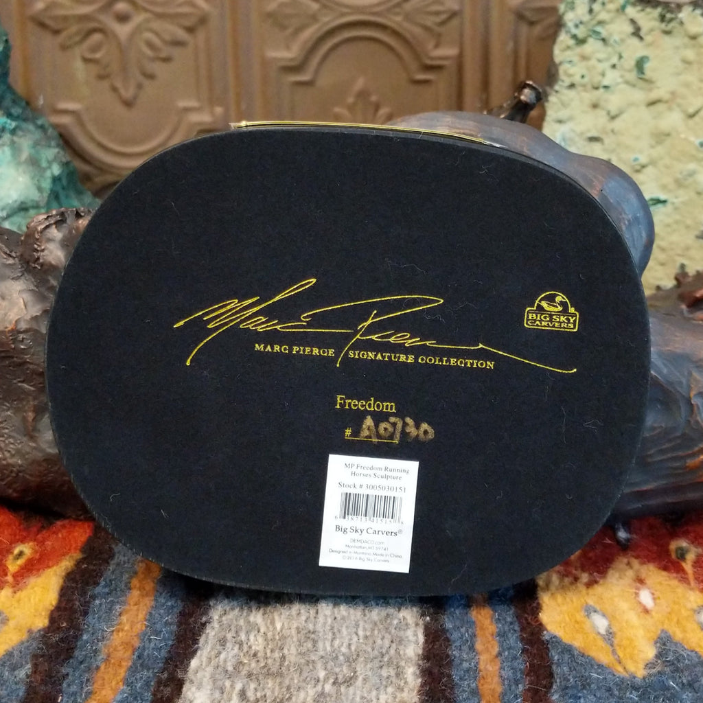 The artist's signature is on the bottom of the base.