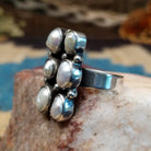 Sterling silver ring with freshwater pearl set in six bezels, framed by dotted accents.