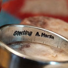 Close-up of the artisan's stamped signature.