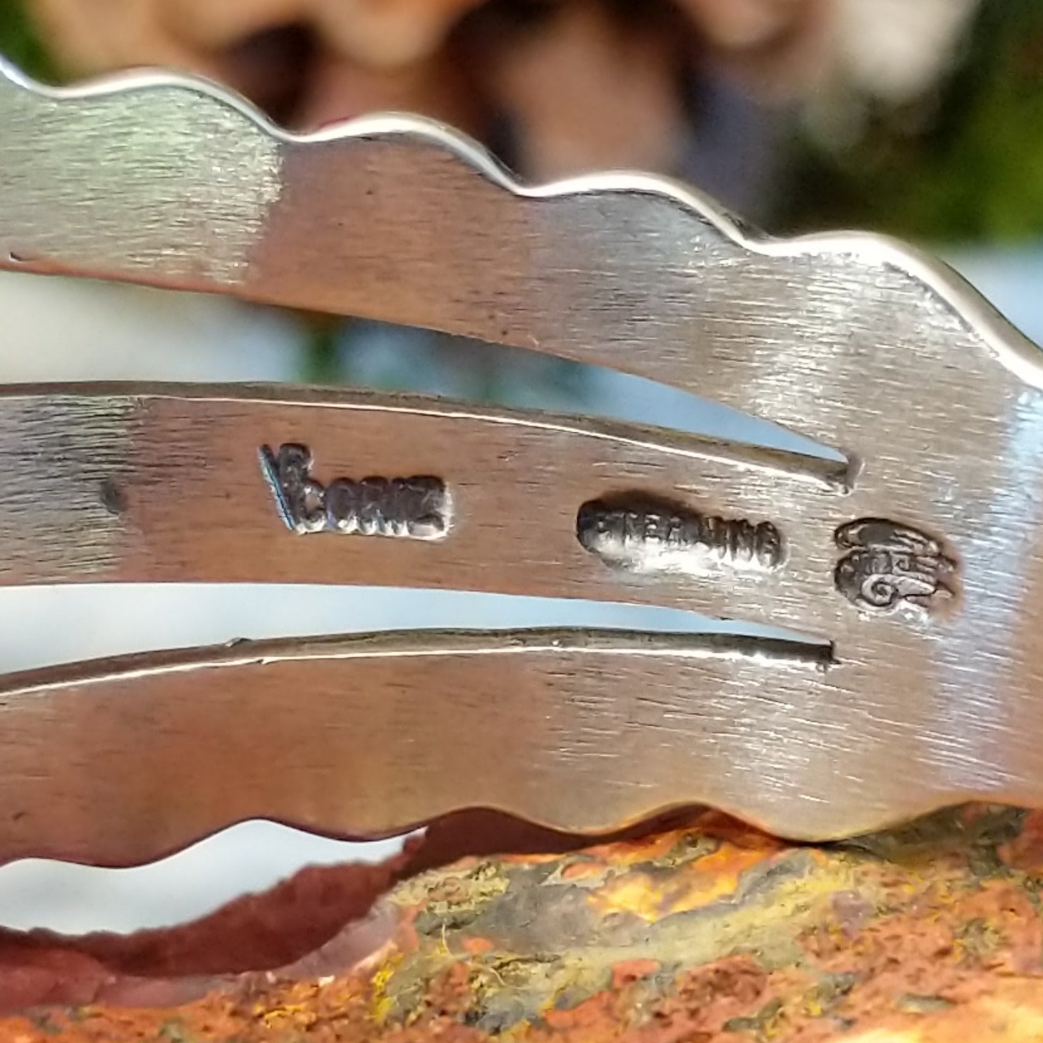 Close-up of the artisan's stamped signature.