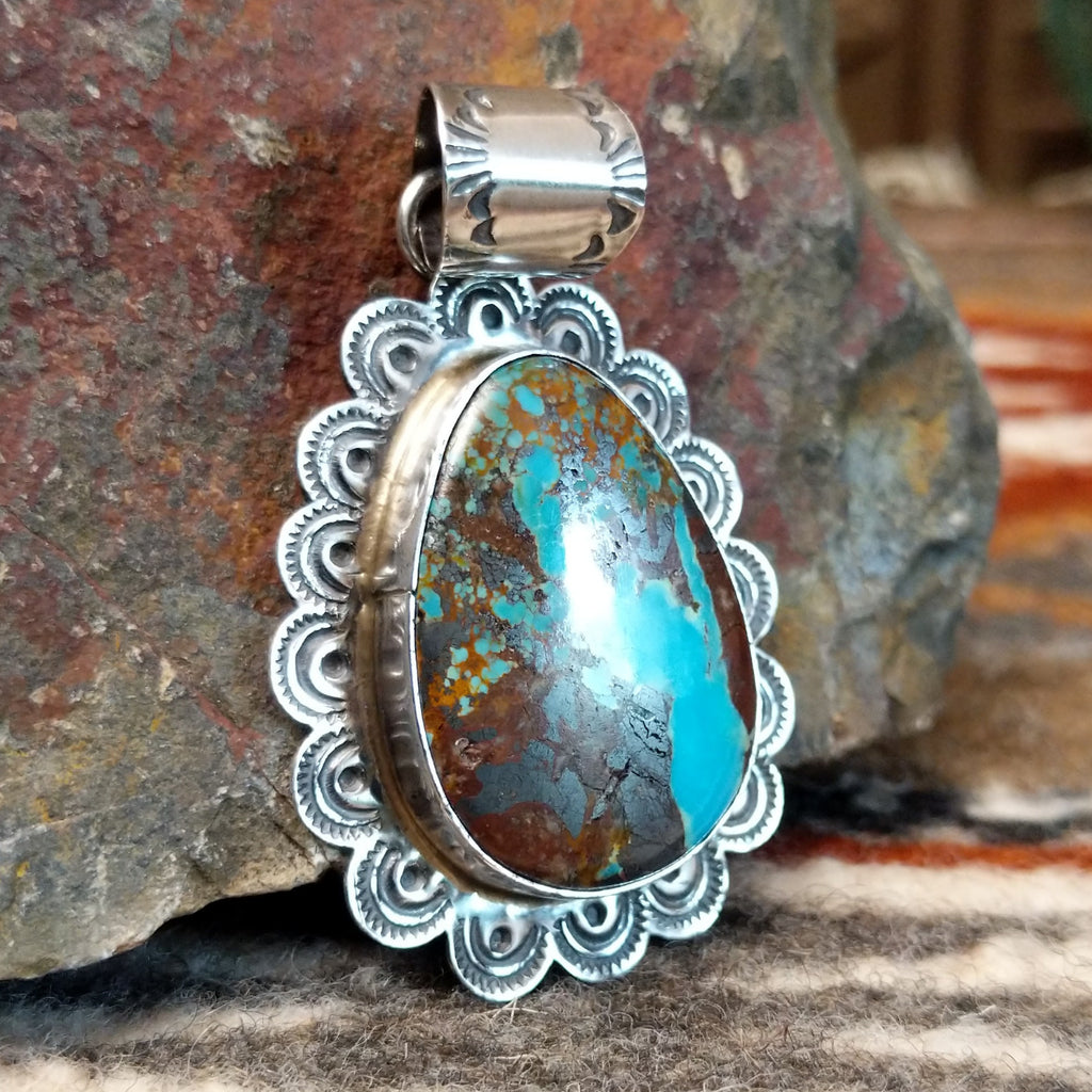 Sterling silver pendant with frilled edges and Redskin Turquoise centerpiece.