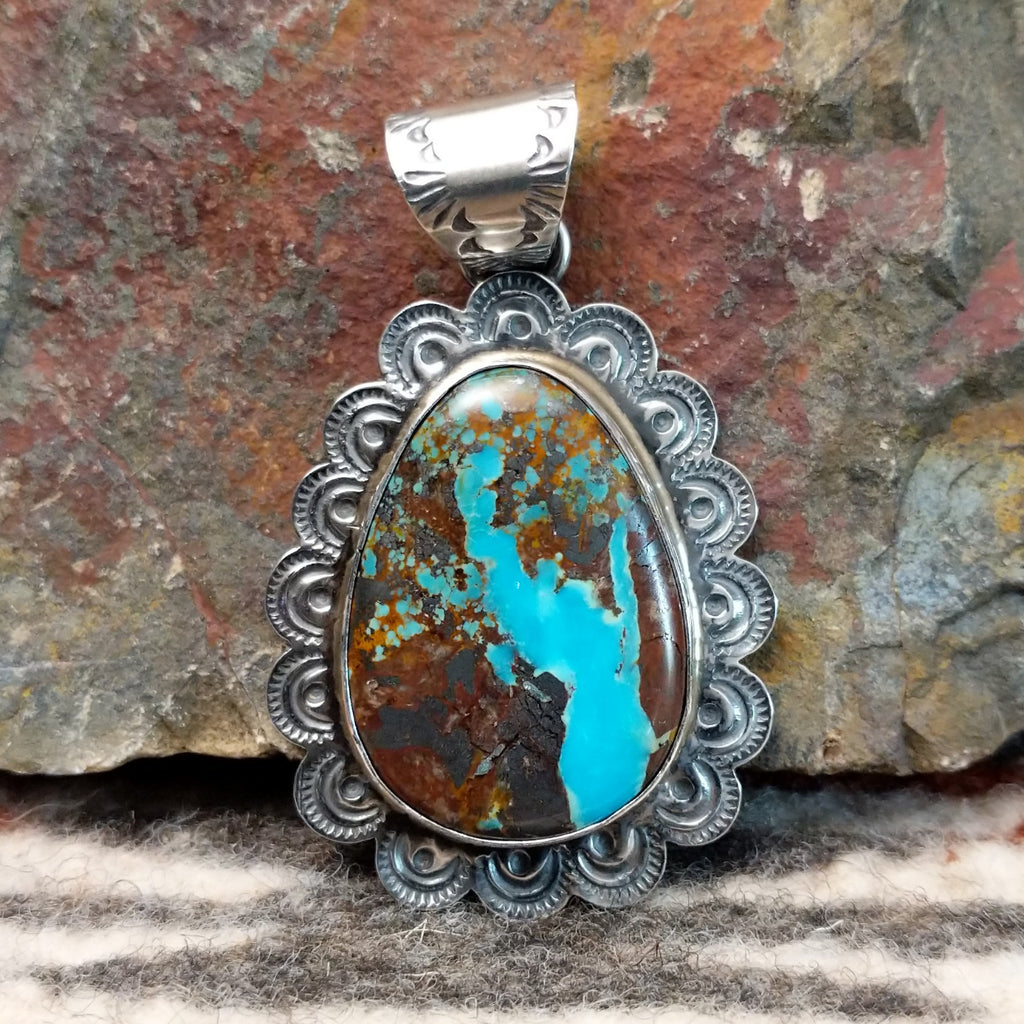 Sterling silver pendant with frilled edges and Redskin Turquoise centerpiece.