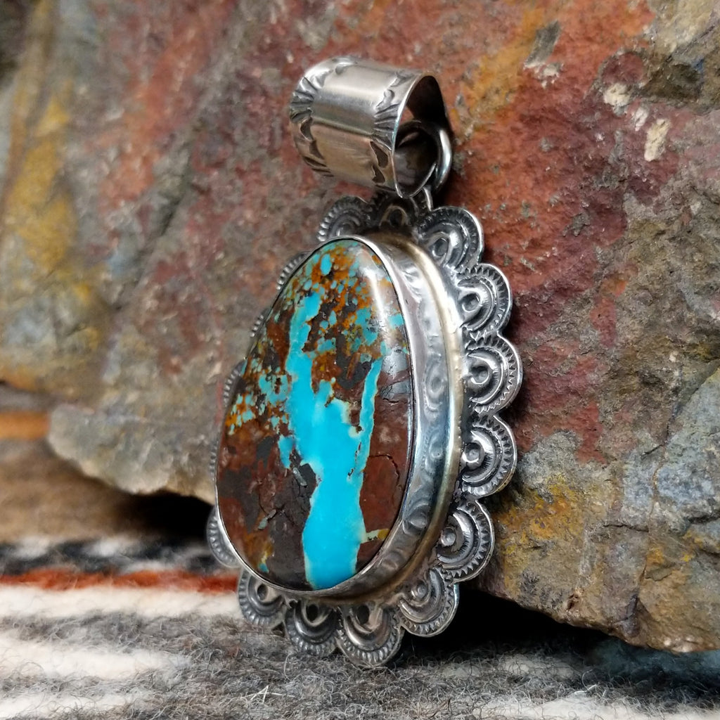 Sterling silver pendant with frilled edges and Redskin Turquoise centerpiece.