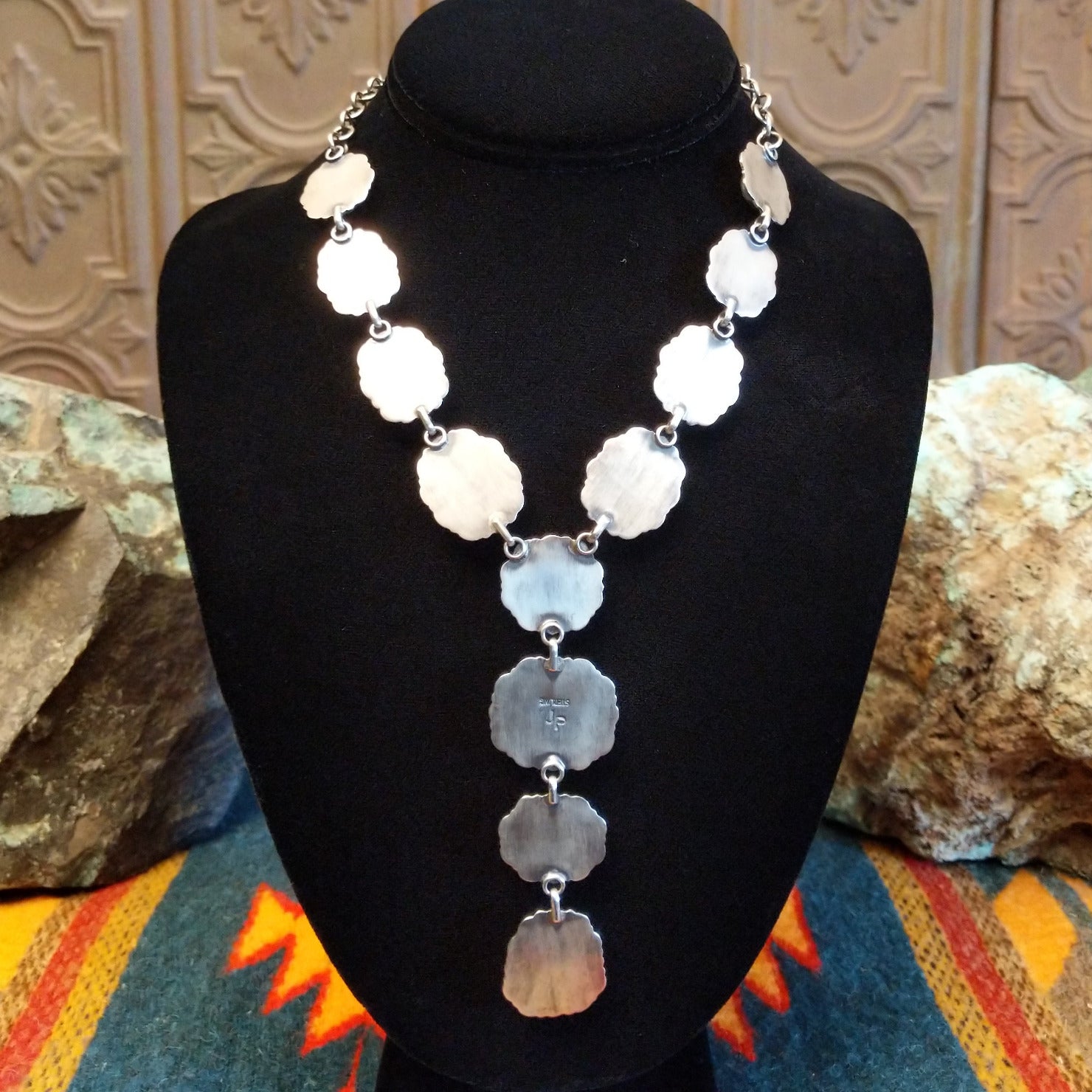 The back of the necklace features the smooth sterling silver settings.