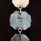 Close-up of the artisan's stamped initials.