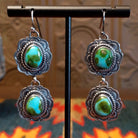 Earrings with Sonoran Gold turquoise set in sterling silver bezels, framed by twisted rope and frilled-edge settings.