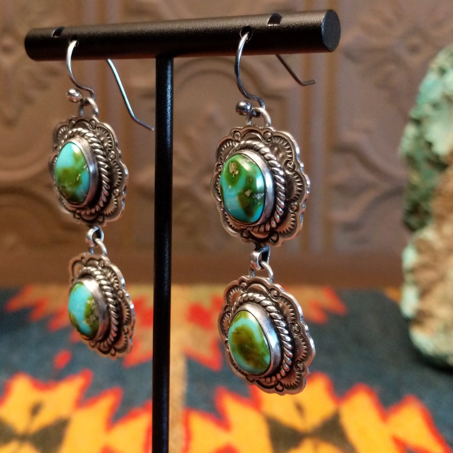 Earrings with Sonoran Gold turquoise set in sterling silver bezels, framed by twisted rope and frilled-edge settings.