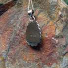 Turquoise pendant by Burt Francisco featuring a large teardrop-shaped blue turquoise stone surrounded by twisted rope and scalloped sterling silverwork; artisan and .925 (Sterling Silver) stamp.