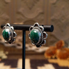 Sterling silver earrings with malachite set in bezels, framed by twisted rope accents and frilled edges.
