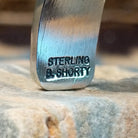 Close-up of the artisan's stamped signature.