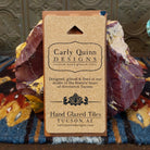 Corkboard backing with artist details.