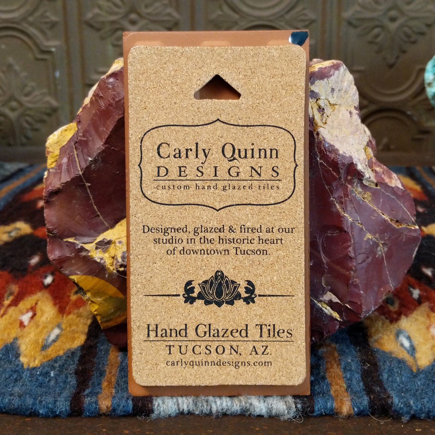 Corkboard backing with artist details.