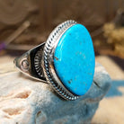 Sterling silver ring with Kingman turquoise set in the gibbous-shaped bezel, framed by twisted rope accents.