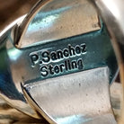 Close-up of the artisan's stamped signature.