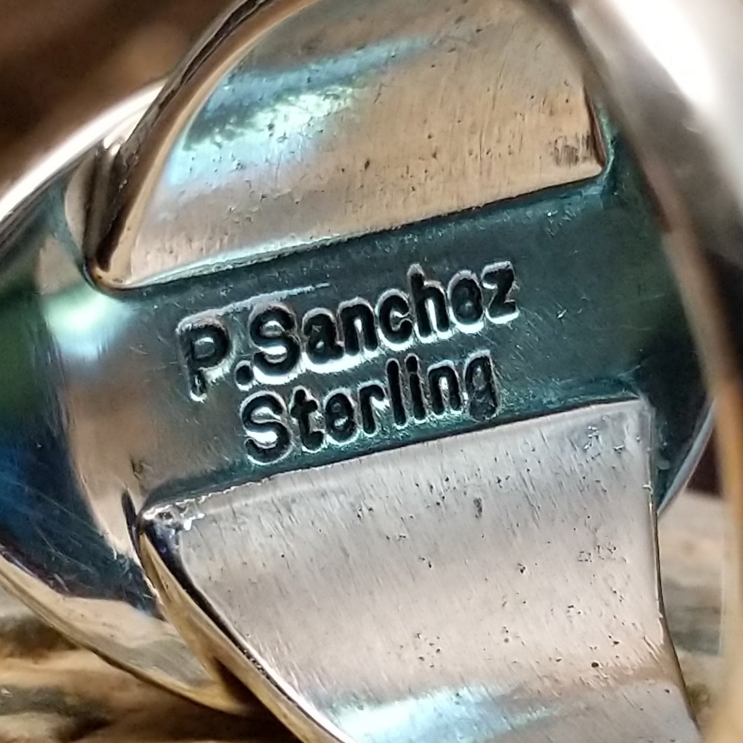 Close-up of the artisan's stamped signature.