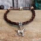 Braided brown horsehair bracelet with a adjustable cord and a metal horse charm.