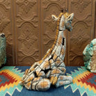 Cast marble of a giraffe calf painted in it's tradition orange and tan coloring.