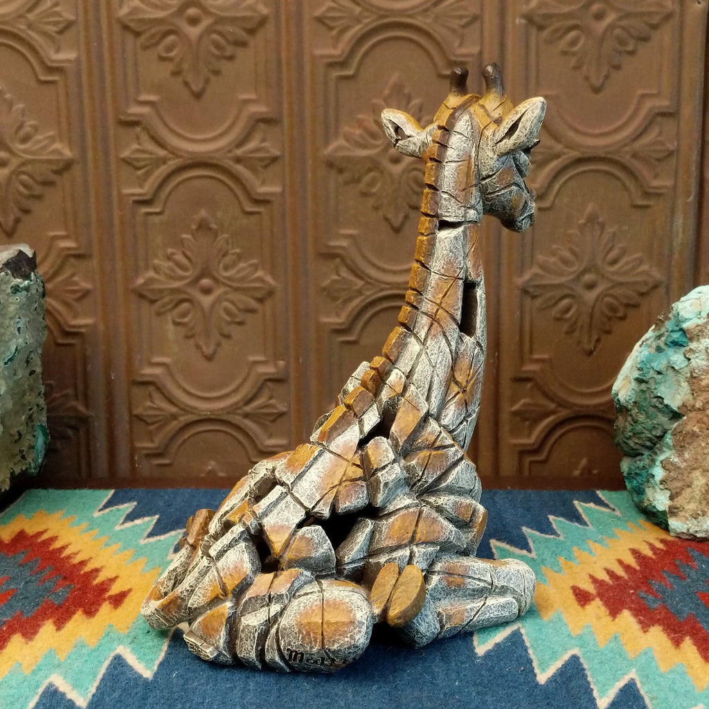 Cast marble of a giraffe calf painted in it's tradition orange and tan coloring.