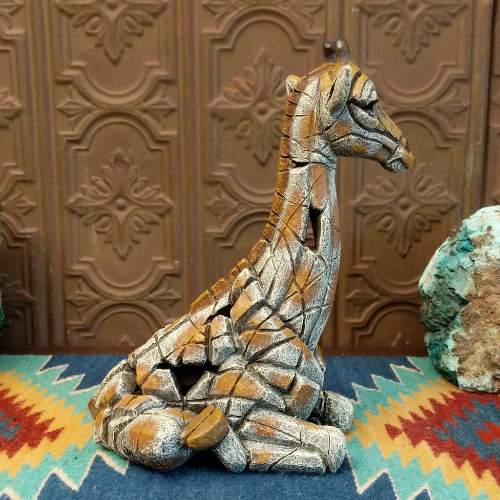 Cast marble of a giraffe calf painted in it's tradition orange and tan coloring.