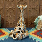 Cast marble of a giraffe calf painted in it's tradition orange and tan coloring.