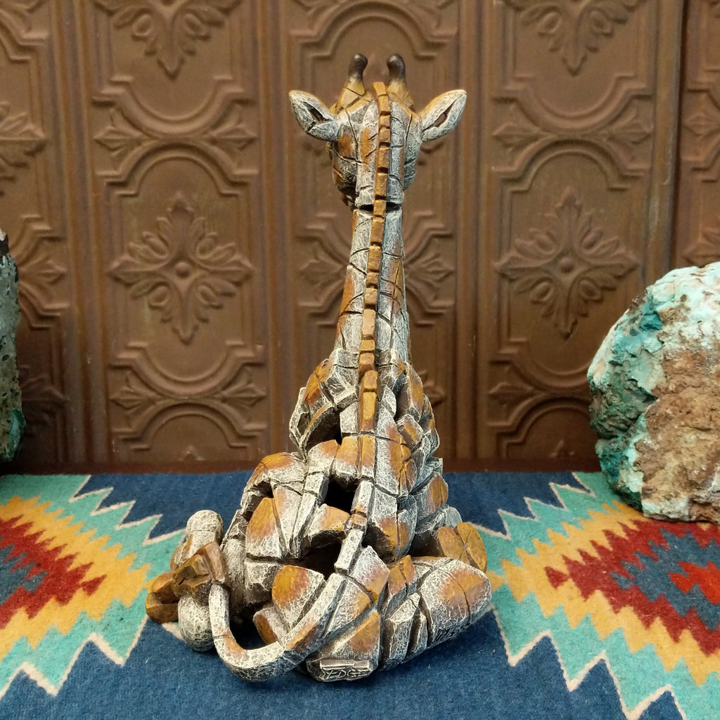 Cast marble of a giraffe calf painted in it's tradition orange and tan coloring.