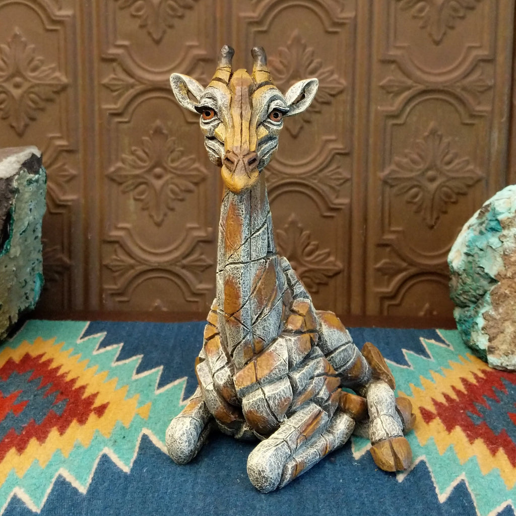 Cast marble of a giraffe calf painted in it's tradition orange and tan coloring.