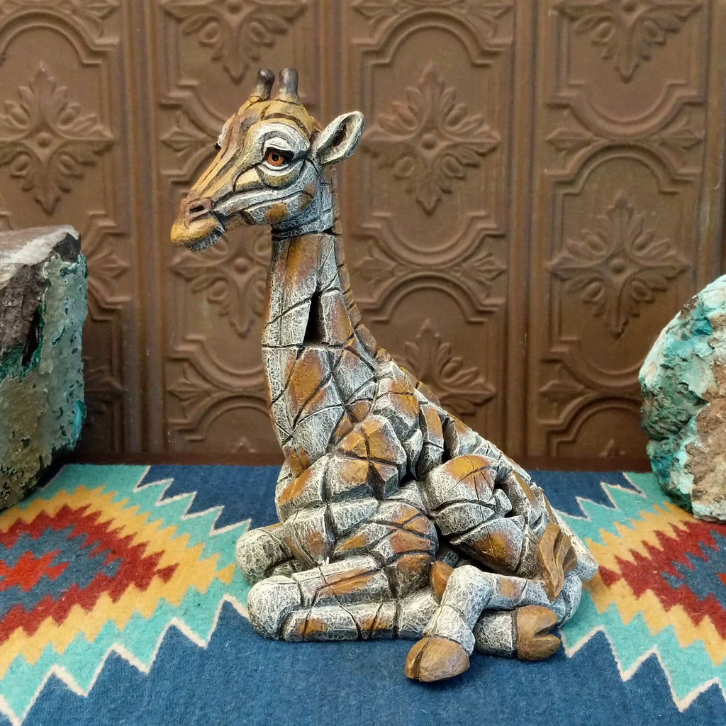 Cast marble of a giraffe calf painted in it's tradition orange and tan coloring.