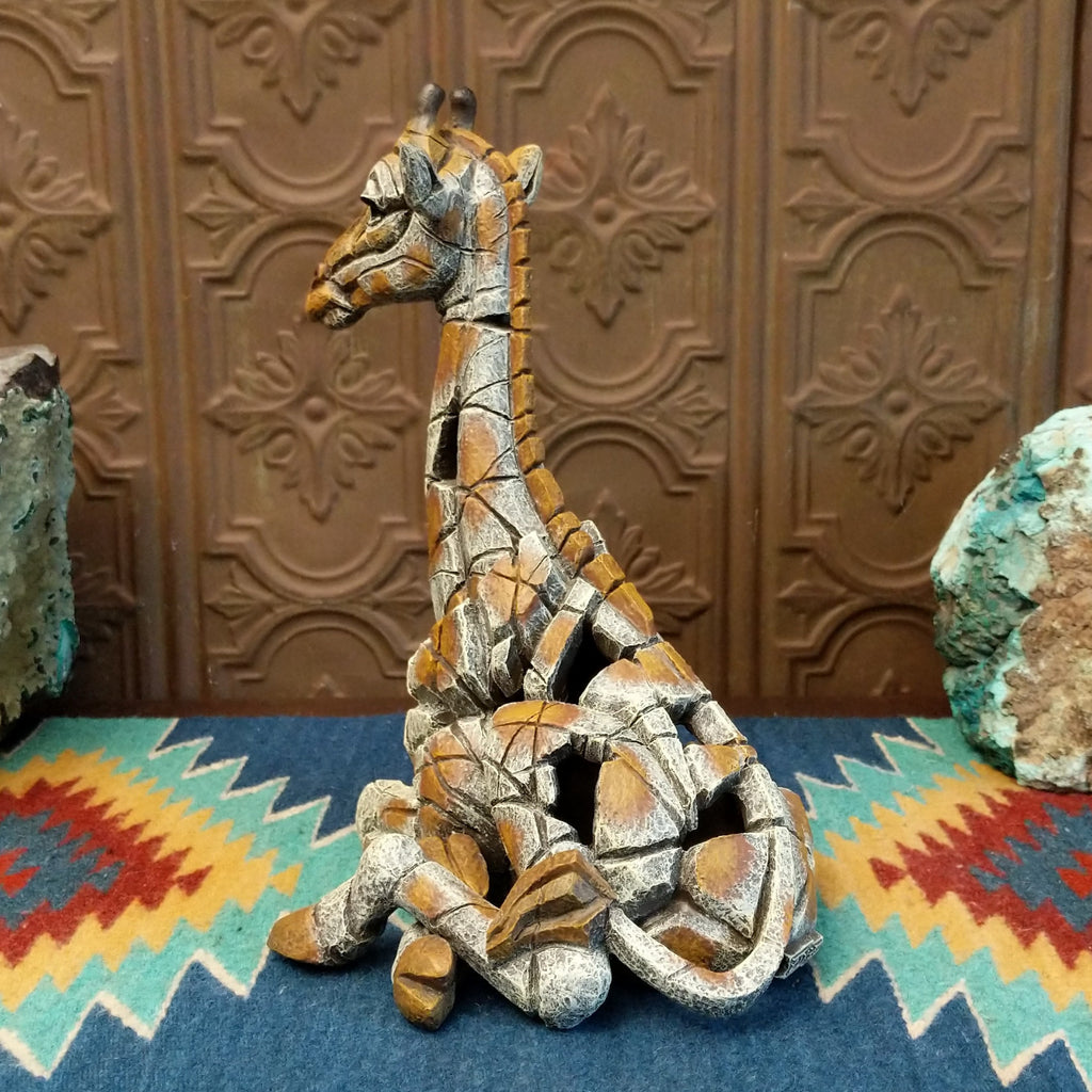 Cast marble of a giraffe calf painted in it's tradition orange and tan coloring.