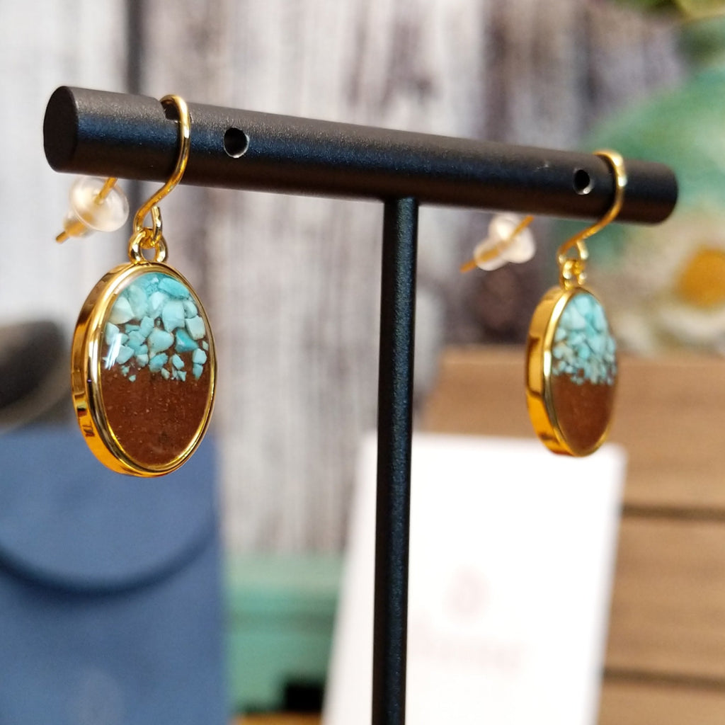 A pair of gold-plated brass drop earrings with oval settings.