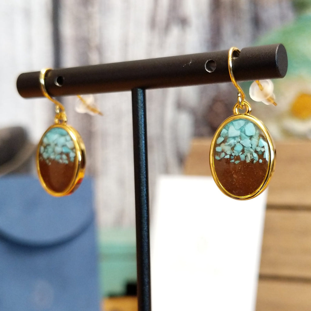 A pair of gold-plated brass drop earrings with oval settings.