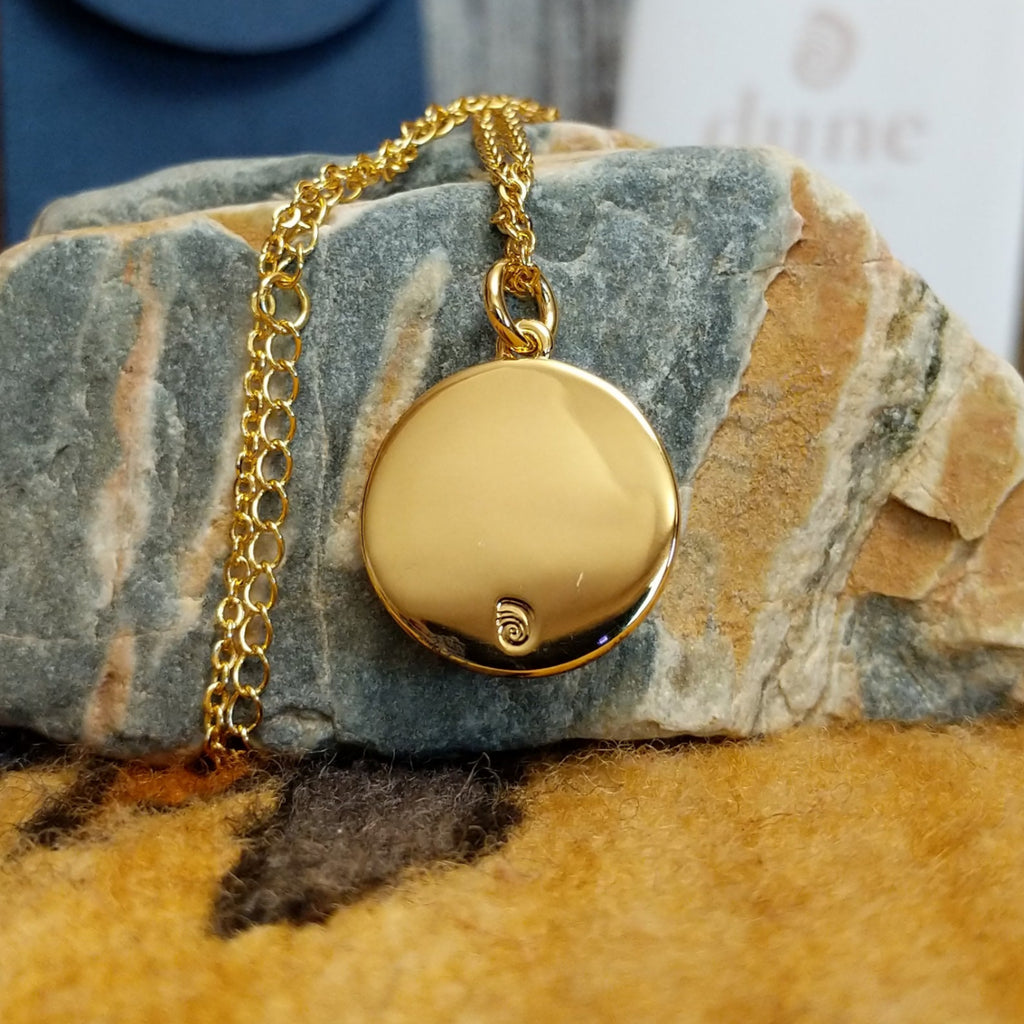 Smooth gold-plated brass with the Dune Jewelry trademark. 