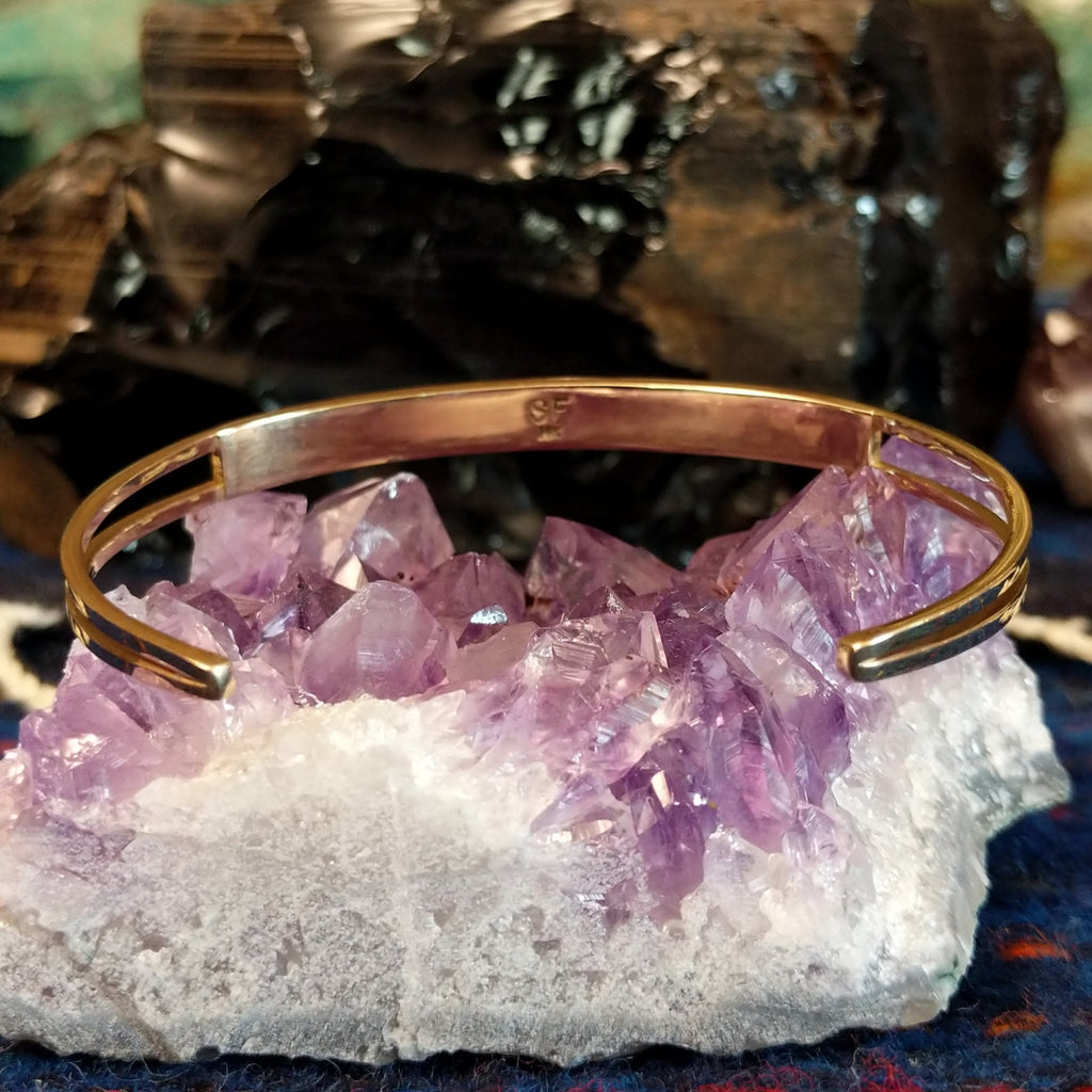 The back of the bracelet features the polished gold finish of the bracelet.