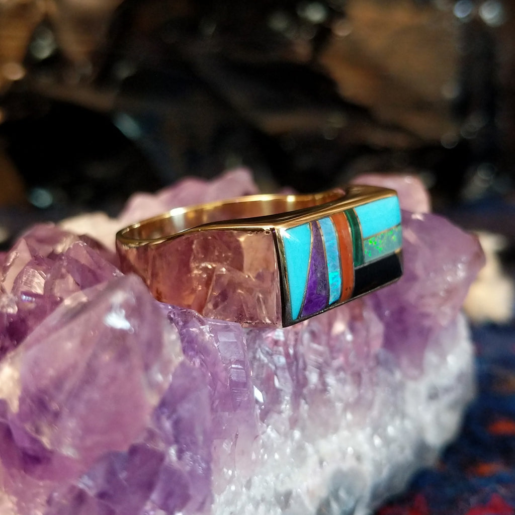 Gold rectangular ring featuring a vibrant multi-stone inlay set in 14k gold.