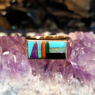 Gold rectangular ring featuring a vibrant multi-stone inlay set in 14k gold.