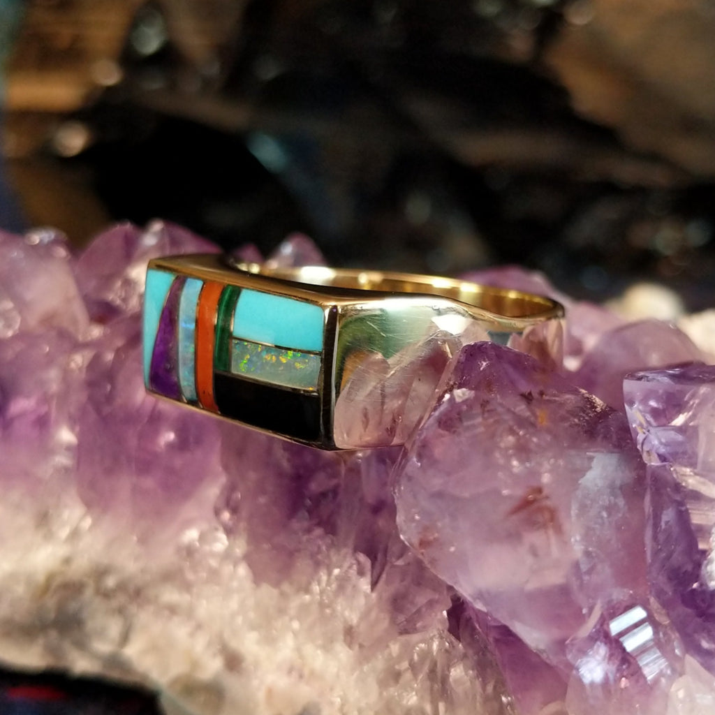 Gold rectangular ring featuring a vibrant multi-stone inlay set in 14k gold.