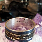 Artist's signature is etched into the inside of the ring.