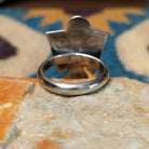 Handcrafted Navajo sterling silver Thunderbird ring by Lowell Draper featuring an oval Golden Hill turquoise cabochon with natural dark matrix, set in a traditional hand-cut Thunderbird design with an oxidized finish; underside view.