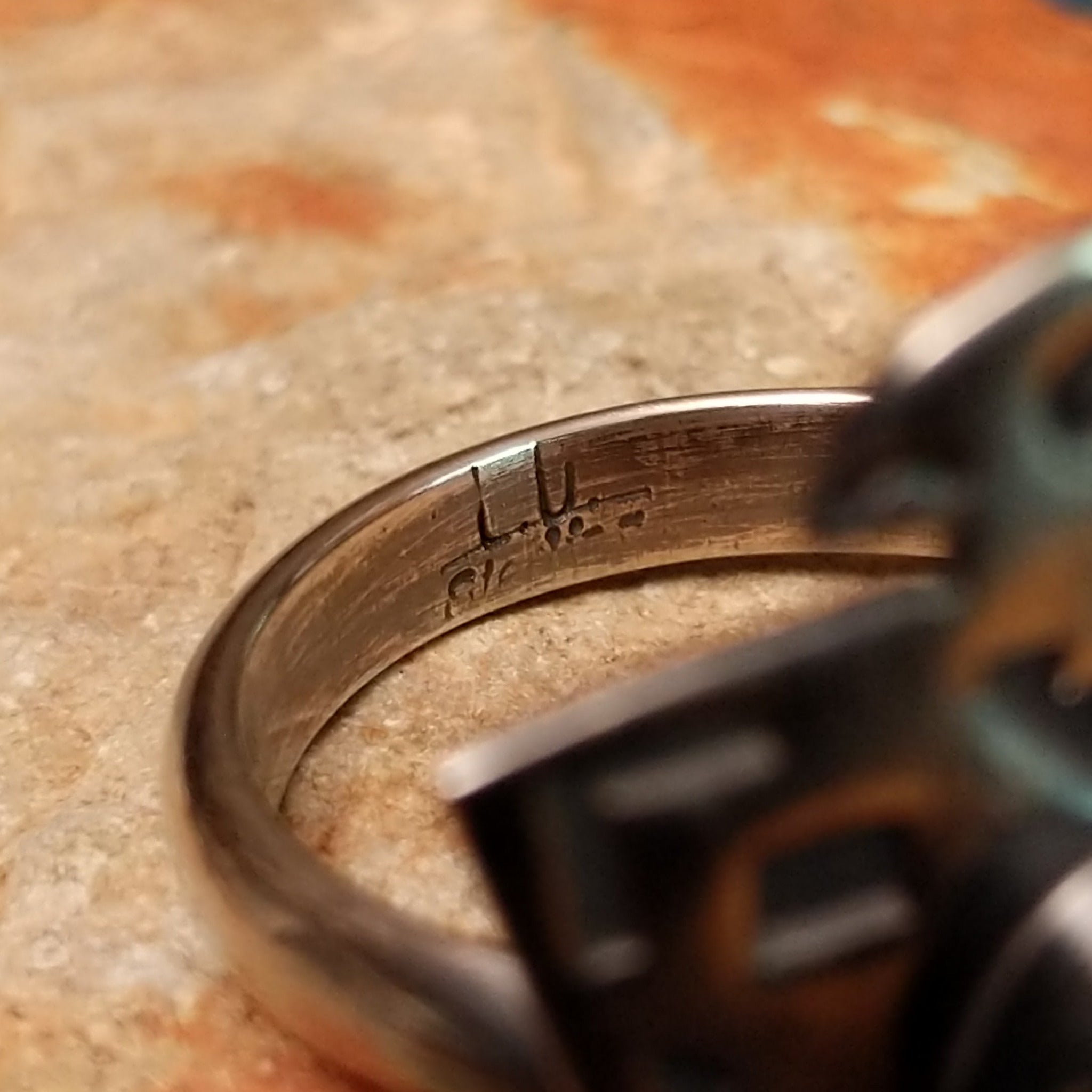 Handcrafted Navajo sterling silver Thunderbird ring by Lowell Draper featuring an oval Golden Hill turquoise cabochon with natural dark matrix, set in a traditional hand-cut Thunderbird design with an oxidized finish; artisan and Sterling Silver stamp.