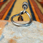 Golden Hills Turquoise Ring by Raymond Coriz featuring two oval light blue turquoise stones with natural matrix, set at opposite ends of a polished silver band with an elegant, flowing design; underside view.