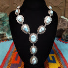 Golden Hills turquoise necklace by Randall Endito with linked scalloped silver settings and three descending center stones.